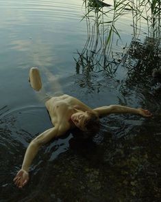 a naked man is floating in the water