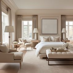 a large bedroom with white furniture and beige curtains on the window sill, along with two couches