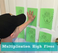 a young boy is making handprints on the door to help him learn how to write