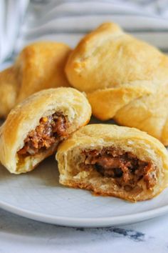 two pastries on a plate with one cut in half