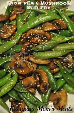 green beans, mushrooms and sesame seeds on a white plate