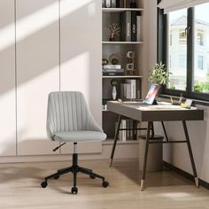 an office chair sits in front of a desk with a laptop on it and bookshelves behind it