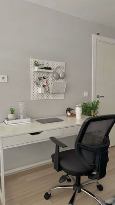 an office chair sitting in front of a white desk