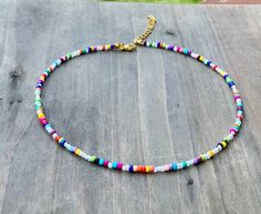 Multi Colored dainty seed bead Choker/ Necklace A colorful mix of beads give this necklace a fun and cheery look. Finished with long lasting and hypoallergenic genuine gold clasps and extension chain. <3 Fast shipping and special requests are always welcomed <3 Bohemian Letter Beads Choker Gift, Multicolor Choker For Summer Gift, Trendy Multicolor Letter Beads Choker, Multicolor Summer Choker As Gift, Multicolor Summer Choker For Gift, Adjustable Rainbow Beaded Choker Necklaces, Multicolor Tiny Beads Choker For The Beach, Colorful Heishi Beads Choker As Gift, Adjustable Multicolor Tiny Beads Choker