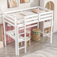 a white bunk bed sitting on top of a hard wood floor next to a wall