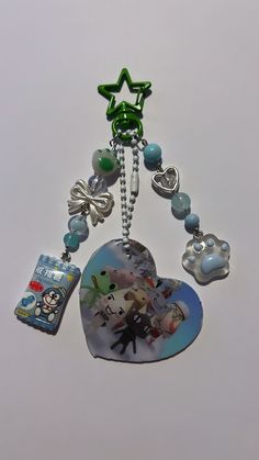 a heart shaped keychain with charms attached to it