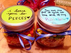 two jars filled with candy sitting on top of a table