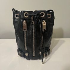 Saint Laurent Small Rider Bucket Bag In Black Leather With Silver Hardware Crossbody Bag Lightly Used. Great Condition. 100% Calfskin Leather. Silver Zippers And Hardware Including Belted Buckles. Zippers Open And Drawstring Adjusts. Leather Crossbody Strap Adjusts. Measurements: H 8in X Bucket Bag Diameter Of Circular Bottom 5 Inches X Half Around Seam To Seam Horizontally 9.5 In 100% Authentic. Dustbag Included. *Photo With Model To Show Size Only* Offers Welcome Silver Zipper, Saint Laurent Bag, Leather Silver, Crossbody Strap, Silver Hardware, Leather Crossbody, Bucket Bag, Calf Skin, Saint Laurent