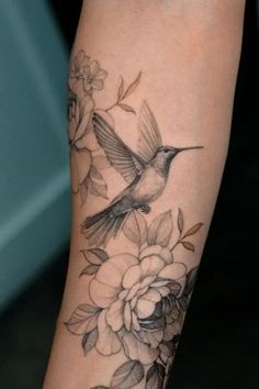 a bird with flowers on its arm