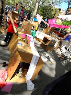 cardboard boxes are stacked on top of each other in the middle of a playground area