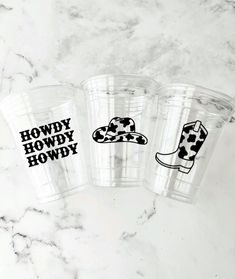 three plastic cups with the words howdy howdy on them sitting next to each other