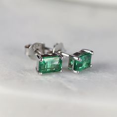 14k gold emerald cut emerald stud earrings. Sophisticated and elegant studs. DETAILS ABOUT THE EARRINGS, MATERIAL AND STONES Settings, posts and backings : 14K solid gold Gemstone: Lab grown Emerald Emerald size: 6mm x 4mm emerald cut Yellow gold or white gold options available from drop down menu. It is a great birthday gift for your special ones whose birthday are in May, since Emerald is May birthstone. This solid gold earrings make a perfect present for your anniversaries. Emerald is especia 20th Anniversary Gifts, Emerald Earrings Studs, Solid Gold Earrings, Great Birthday Gifts, Emerald Earrings, Anniversary Gift For Her, Emerald Cut, Stone Settings, Gemstone Earrings