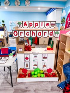 the children's apple orchard is set up in their playroom with wooden shelves