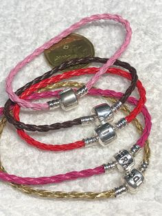 Bracelet lot, assorted colors, all leather bracelets, mixed lot, new never used 5 pandora like Leather bracelets, new never used other than display 2 sterling and 3 stamped Pandora/faux colors are gold, dark pink and light pink, 7 inches,  red and brown, 6 inches 5 total packed and sent with care Red And Brown, Leather Bracelets, Dark Pink, Rope Bracelet, 6 Inches, Leather Bracelet, Light Pink, Bracelet, Beads