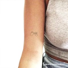 a woman's arm with a small tattoo on the left side of her arm