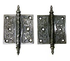 two metal door hinges with ornate designs on them