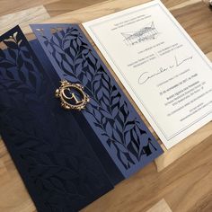 the wedding stationery is laid out on top of the wooden table, ready for guests to arrive