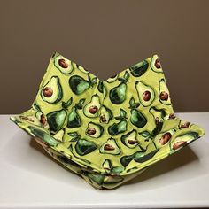 an avocado shaped bowl sitting on top of a table