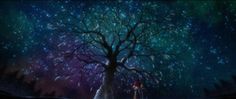 two people standing in front of a tree under the night sky with stars above it