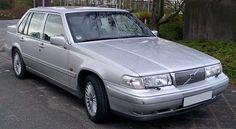 a silver car is parked on the side of the road