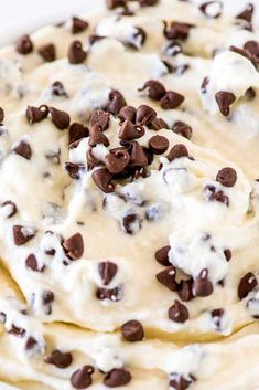 a cookie dough with chocolate chips and cream on top is ready to be baked in the oven