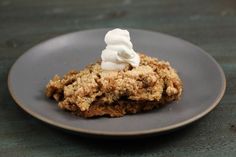 a piece of cake with whipped cream on top sits on a plate, ready to be eaten