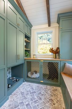 a kitchen with green cabinets and an oven