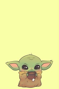 the baby yoda is holding something in its hands and looking at it's mouth