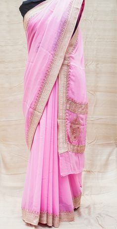 Category: Georgette Saree An exclusive Banarasi saree from Khinkhwab. Add a dash of your favorite color to your ethnic look with this beautiful Banarasi saree. Fabric - Pure Georgette Silk Georgette is a lightweight, crinkled and sheer fabric, displaying an overall bouncy look. A strong absorbent, Georgette is easy to dye and has a dull-rough texture. Georgette is made from twisting yarns of silk. Color -Pink Weave - Kadwa Craftsmanship - Ari zardozi work material used: Dabka(Saadi),sequins, res Eid Puja Pre-draped Saree With Embroidered Border, Eid Anarkali Pre-draped Saree With Pallu, Pink Raw Silk Pre-draped Saree With Resham Embroidery, Dola Silk Pre-draped Saree With Embroidered Border For Puja, Traditional Designer Pre-draped Saree For Navratri, Eid Puja Pre-draped Saree With Resham Embroidery, Transitional Festive Pre-draped Saree With Embroidered Border, Eid Traditional Zari Weaving On Georgette Wear, Eid Traditional Georgette Wear With Zari Weaving