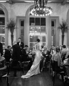 the bride and groom are standing in front of their guests