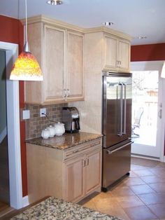 a kitchen with granite counter tops and stainless steel appliances