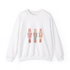 Look absolutely adorable in this Preppy Croquette Nutcracker Unisex Heavy Blend™ Crewneck Sweatshirt Preppy Croquette Nutcracker, Pink, Greens, Cute, Darling, Women's Preppy Croquette Sweatshirt, Holiday Sweatshirt, Christmas Sweatshirt, Nutcracker Sweatshirt Ideal for any situation, a unisex heavy blend crewneck sweatshirt is pure comfort. These garments are made from polyester and cotton. This combination helps designs come out looking fresh and beautiful. The collar is ribbed knit, so it retains its shape even after washing. There are no itchy side seams on these sweaters.  .: Made with a medium-heavy fabric blend of 50% cotton and 50% polyester (8.0 oz/yd² (271.25 g/m this sweatshirt feels cozy and is the perfect choice for those colder months. .: The classic fit along with the crew ne Winter Cartoon Print Sweatshirt For Loungewear, Winter Loungewear Sweatshirt With Cartoon Print, Winter Cartoon Print Tops For Loungewear, Holiday Graphic Print Sweater For Fall, Nutcracker Sweater, Nutcracker Pink, Coquette Sweatshirt, Sweatshirt Preppy, Cozy Winter Fashion