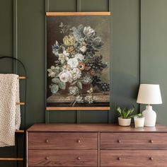 a painting hanging on the wall above a dresser