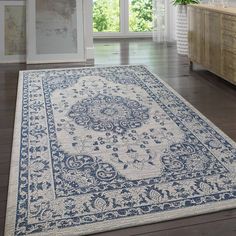 a large blue and white rug in a living room