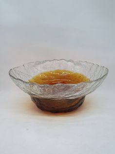 a glass bowl filled with liquid sitting on top of a table