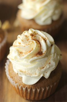 cupcakes with white frosting and cinnamon sprinkles