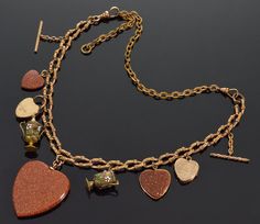 "Very rare fancy chain necklace with heart charm pendants C.1860. Be it Victorian era or nowadays heart is a very much loved symbol in jewelry. The necklace is 21 1/2\" long end to end. It consists of fancy finely ornate chain 12\" long 8 mm wide and finely ornate chain extender 9 1/2\" long 4 mm wide. The 9 charm pendants are: 1. Fancy gold filled 26 mm long twisted T-bar (19 mm high with chain) 2. 2-picture heart locket 19 mm X 17 mm. The front and back are 9K gold, gold filled interiors. The Collectible Yellow Gold Necklace With Heart Charm, Victorian Necklaces With Charms For Anniversary, Victorian Yellow Gold Necklace With Heart Charm, Victorian Antique Gold Heart Pendant Necklace, Victorian Antique Gold Necklaces For Valentine's Day, Victorian Antique Gold Necklace For Valentine's Day, Victorian Heart Charm Pendant Necklace, Victorian Yellow Gold Heart Pendant Necklace, Antique Yellow Gold Necklaces For Valentine's Day