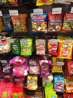 many bags of candy are on display in a store