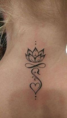 a woman's neck with a tattoo on the back of her neck and a heart