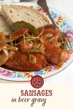 sausages in beer gravy on a floral plate with a fork and knife