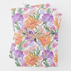 two wrapped gift boxes with colorful flowers on them