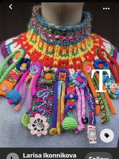 a woman wearing a multicolored crochet necklace with lots of colorful beads