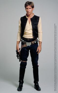 Inspiration for Han Solo’s gun belt was drawn from Spaghetti Westerns, so the hero always had “a good blaster” at his side. Throughout all three of the original Star Wars trilogy films, Solo’s costume remains consistent with only minor modifications to the base pieces. Design by: John Mollo (based on sketches by Ralph McQuarrie) #StarWarsCostumes #behindtheseams Han Solo Cosplay, Star Wars Halloween, Black Halloween Dress, Solo Costume, Star Wars Costumes, Han Solo