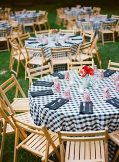 tables and chairs are set up in the grass for an outdoor dinner party with black and white checkered tablecloths