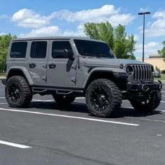 a gray jeep parked in a parking lot