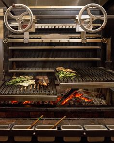 an open grill with food cooking on it and two burners in the middle,