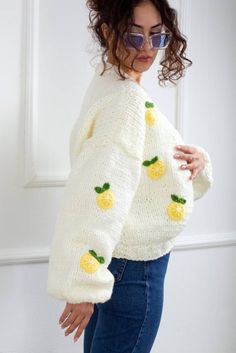 a woman wearing a sweater with lemons on it