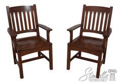 two wooden chairs sitting next to each other