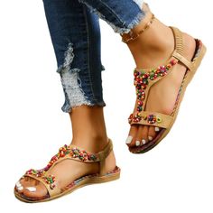 Step out in style with these Women's Roman Sandals. The open toe design and round toe shape add a touch of elegance to your casual outdoor look. Made with high-quality materials, these sandals are not only fashionable but also comfortable to wear. Perfect for strolling around the city or a day at the beach, these Bohemian-inspired sandals will definitely elevate your summer wardrobe. Pair them with a flowy dress or denim shorts for a chic and trendy ensemble. Embrace fashion-forward style with t Beach Season T-strap Sandals With Round Toe, Bohemian Toe Post T-strap Sandals For Summer, Bohemian T-strap Sandals For Summer, Bohemian T-strap Toe Post Sandals For Summer, Toe Post Slingback Sandals For Beach Vacation, Trendy Spring T-strap Sandals With Cushioned Footbed, Summer Flat T-strap Sandals With Cushioned Footbed, Bohemian T-strap Sandals With Round Toe For Summer, Bohemian Summer Beach Slingback Sandals