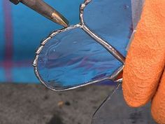 an orange glove holding a pair of glasses